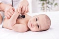 Smiling beautiful happy baby with pediatrician