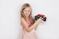 Smiling beautiful little girl getting puppy in gift box for Christmas or Birthday