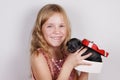 Smiling beautiful little girl getting puppy in gift box for Christmas or Birthday