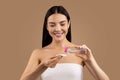 Smiling beautiful naked woman using micellar water and cotton pad Royalty Free Stock Photo