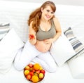 Smiling beautiful pregnant with fruit in hand Royalty Free Stock Photo
