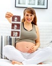 Smiling beautiful pregnant woman with echo in hand Royalty Free Stock Photo