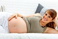 Smiling beautiful pregnant woman relaxing on sofa