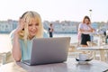 Smiling beautiful teenage girl in headphones looking into laptop Royalty Free Stock Photo