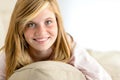 Smiling beautiful teenager girl lying on pillow