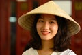 Smiling beautiful vietnamese woman with typical strawhat