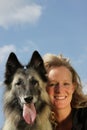 Smiling beautiful woman with Belgian shepherd