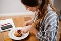 Smiling beautiful woman eating pancakes while having breakfast Royalty Free Stock Photo