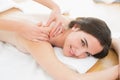 Smiling beautiful woman enjoying shoulder massage at beauty spa Royalty Free Stock Photo