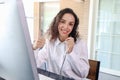 Smiling beautiful woman with headphones give thumb up at call center service desk consultant, call center agent with headset talk Royalty Free Stock Photo