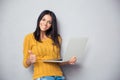 Smiling beautiful woman holding laptop Royalty Free Stock Photo