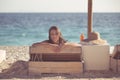 Smiling beautiful woman sunbathing in a bikini on a beach at tropical travel resort Royalty Free Stock Photo