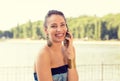 Smiling beautiful woman talking on mobile phone outdoors by the lake Royalty Free Stock Photo