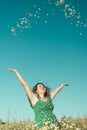 Smiling beautiful woman throwing flowers