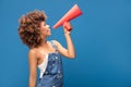 Afro young girl screaming by red megaphone. Royalty Free Stock Photo