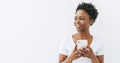 Smiling beautiful young African American woman in white T-shirt using mobile phone isolated on the white background, banner Royalty Free Stock Photo