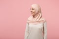 Smiling beautiful young arabian muslim woman in hijab light clothes posing isolated on pink background studio portrait Royalty Free Stock Photo