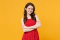 Smiling beautiful young brunette woman girl in red summer dress posing isolated on yellow background studio portrait Royalty Free Stock Photo