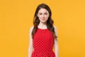 Smiling beautiful young brunette woman girl in red summer dress posing  on yellow background studio portrait Royalty Free Stock Photo