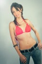 Smiling, beautiful young brunette woman. Swimsuit and jeans. Royalty Free Stock Photo