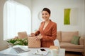 Smiling beautiful young business woman holding one open pink leather handbag putting water bottle inside Royalty Free Stock Photo