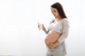 Beautiful pregnant woman holding glass of milk, white background Royalty Free Stock Photo