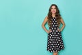 Smiling Beautiful Young Woman Is In Black Coctail Dress In Polka Dots Is Looking At Turquoise Copy Space Royalty Free Stock Photo
