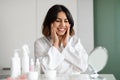 Smiling beautiful young woman looking at mirror at home Royalty Free Stock Photo