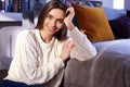 Smiling beautiful young woman relaxing on couch at home Royalty Free Stock Photo