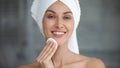 Smiling beautiful woman hold cotton pad cleansing face skin Royalty Free Stock Photo