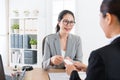 Manager giving young sales girl business card