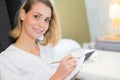 Smiling beauty therapist holding white towels at spa Royalty Free Stock Photo