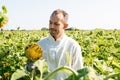 smiling beekeeper in protective suit looking