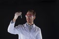 Smiling biologist holding test tube with plant