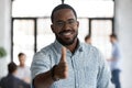 Smiling biracial businessman welcoming new employee at workplace Royalty Free Stock Photo