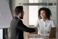 Smiling biracial businesswoman handshake male colleague at briefing Royalty Free Stock Photo