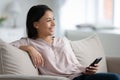 Smiling biracial female use cellphone dream at home