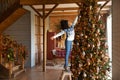 Smiling biracial girl child decorate Christmas tree