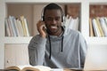 Smiling biracial guy in headphones watch online course on laptop Royalty Free Stock Photo