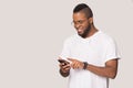 Smiling biracial man using modern cellphone with wireless internet