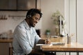 Smiling biracial man watch webinar on laptop make notes Royalty Free Stock Photo