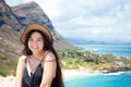 Smiling biracial teen girl with Hawaiian mountain and beach back Royalty Free Stock Photo