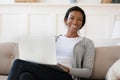 Smiling biracial woman distracted from computer talking with someone Royalty Free Stock Photo