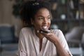 Smiling biracial woman record audio message on cellphone Royalty Free Stock Photo