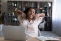 Smiling biracial woman stretch at home office workplace