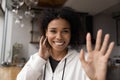 Smiling biracial woman wave at camera talking on video call Royalty Free Stock Photo