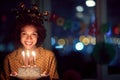 Smiling birthday girl holding birthday cake