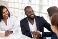 Smiling black businessman handshake male partner at meeting Royalty Free Stock Photo