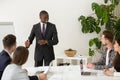 Black coach mentoring diverse work group making presentation Royalty Free Stock Photo