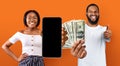 Smiling black couple enjoying victory, gambling online, mockup Royalty Free Stock Photo